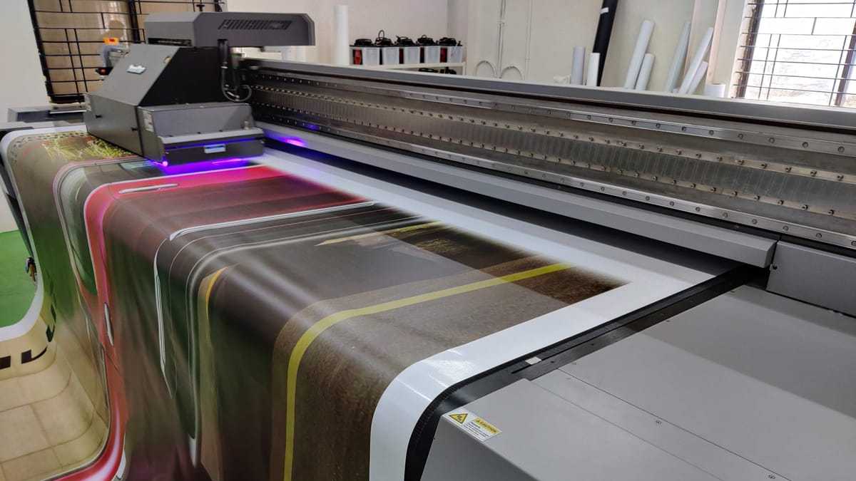 UV flatbed printer curing a large vinyl print at Belur