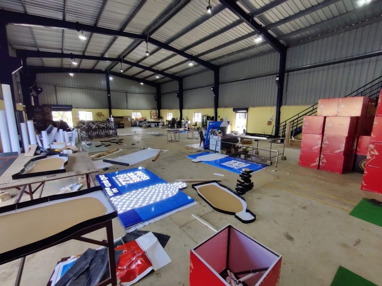 Signage panels and display units mid-assembly on the fabrication floor