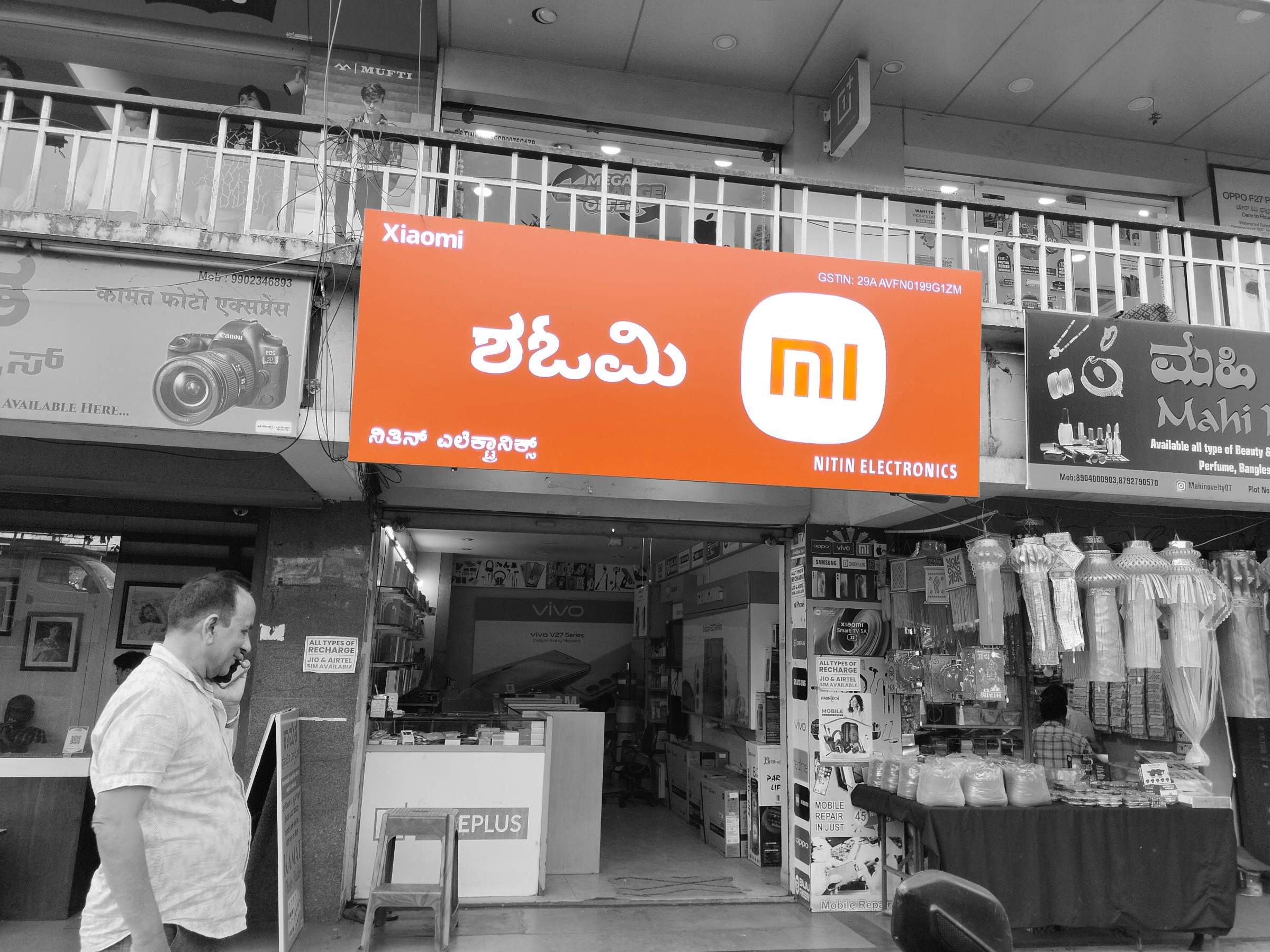 Orange Xiaomi Mi store signboard above a phone shop
