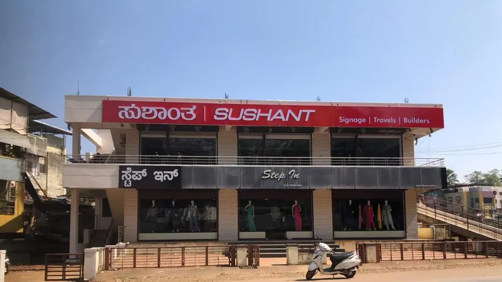 A walk through the Dharwad plant: the Sushant building, the fabrication hall, the production floor with printed panels laid out, the CNC router, a UV flatbed mid-run, and the rooftop solar array.