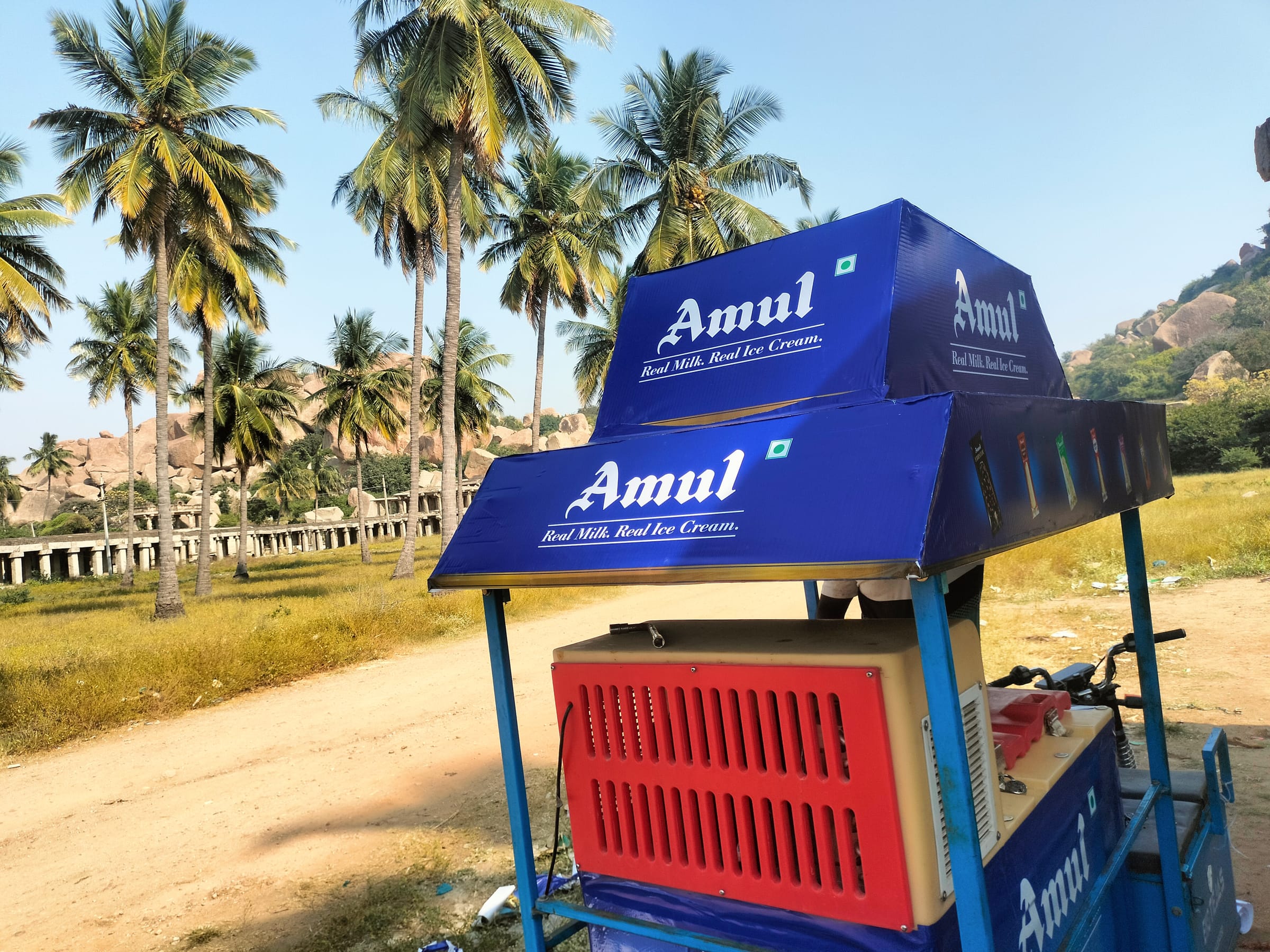 Amul ice-cream cart with a branded canopy near Hampi