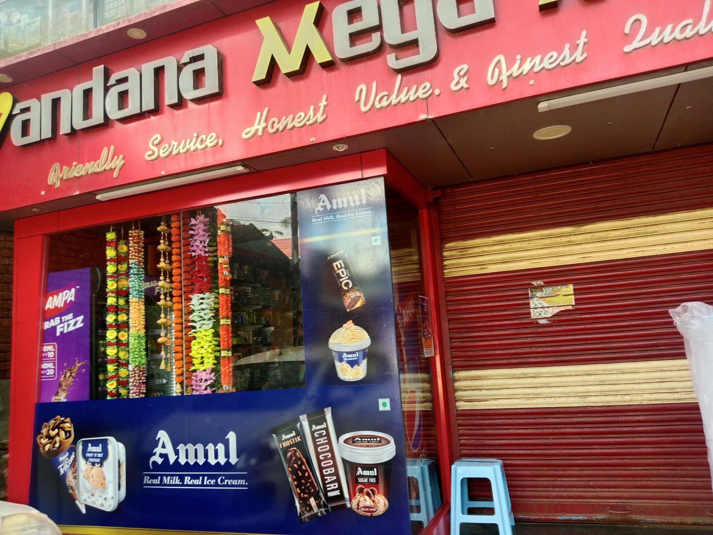 Amul window graphics and freezer branding at a retail store