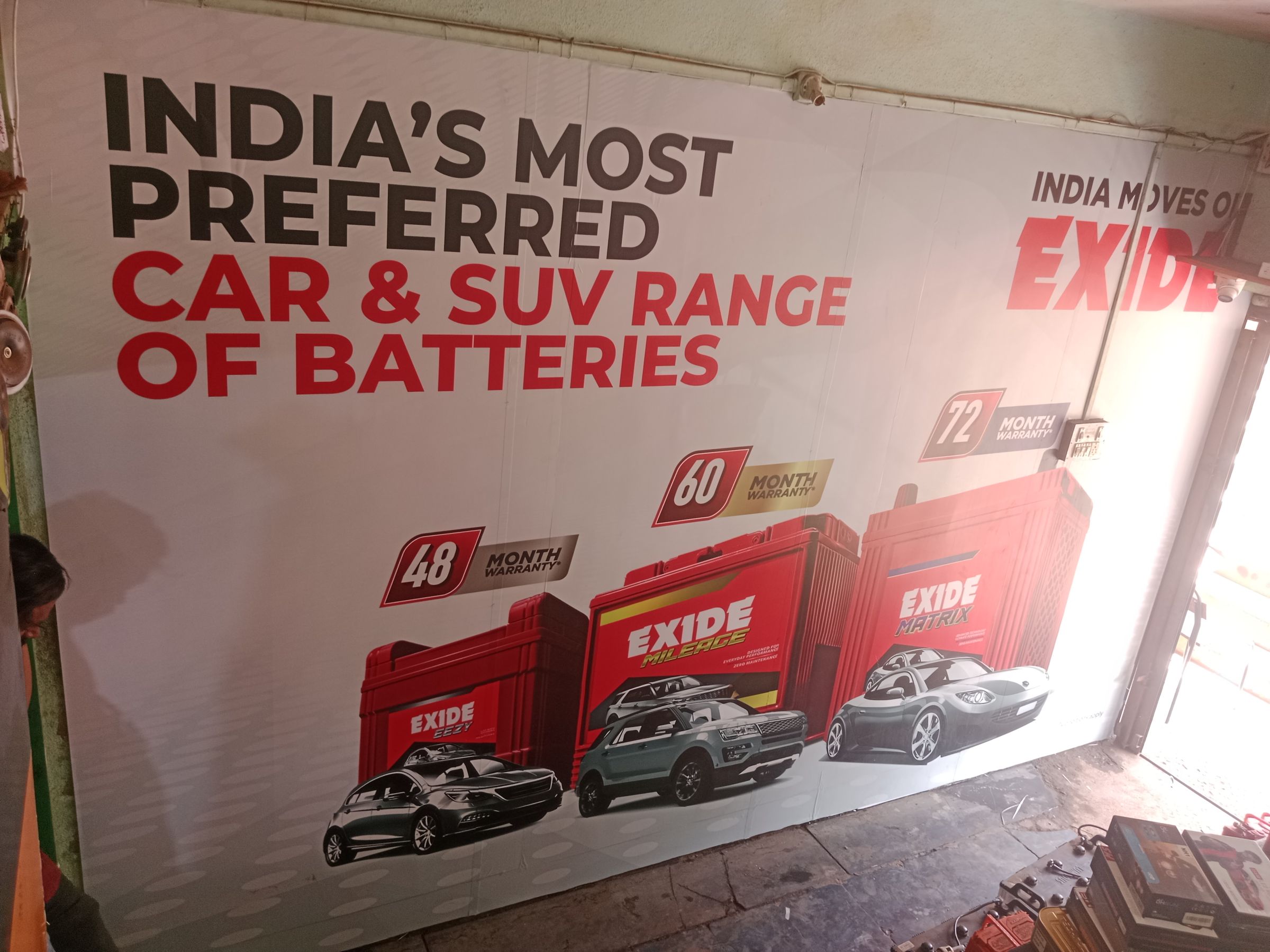In-shop wall graphic for car and SUV batteries at a dealer