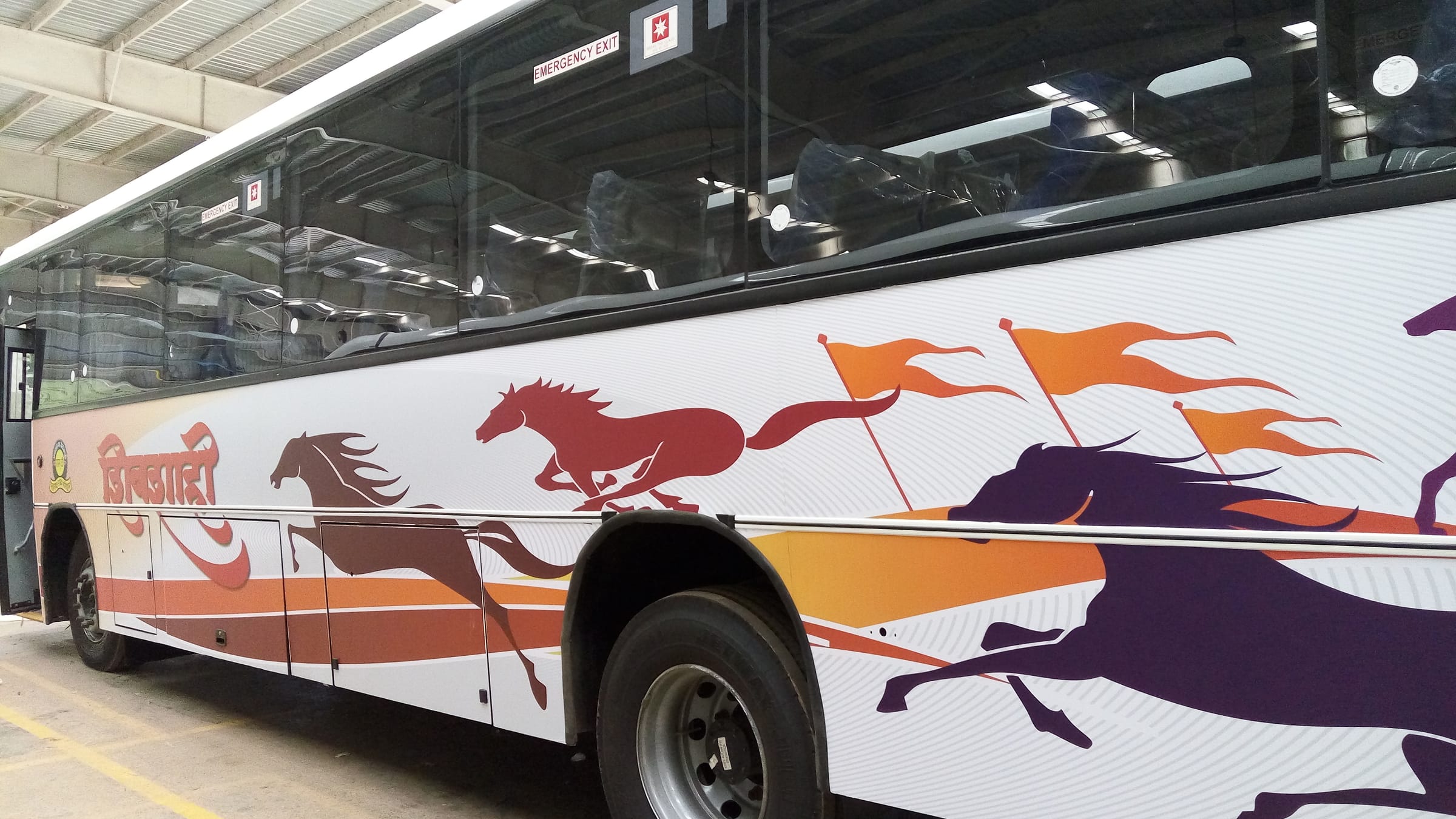 Full-side Shivshahi livery on a coach inside the builder's plant